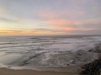a person is standing on a cliff overlooking the ocean